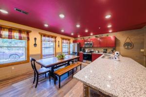 a kitchen with red cabinets and a wooden floor at Lap of Luxury chalet in Gatlinburg