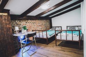 a room with two bunk beds and a table at Mohito Hostel in Kraków