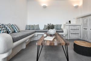 a living room with a couch and a table at Suites of the Gods Cave Spa Hotel in Megalokhori