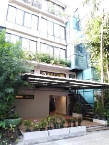 a building with plants on the side of it at Chakrabongse Residences in Bangkok