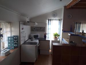 a small kitchen with a sink and a stove at Les Demeures de la Laigne in Allas-Bocage