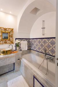 a bathroom with a large tub and a sink at Dar Said in Sidi Bou Saïd