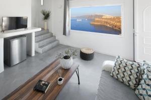 a living room with a couch and a table at Suites of the Gods Cave Spa Hotel in Megalokhori