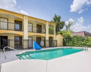 a swimming pool in front of a apartment building at Key West Inn - Montgomery South in Montgomery