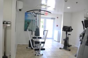 a gym with two exercise bikes in a room at The Grand Caymanian Resort in George Town