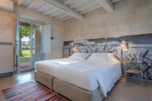 En eller flere senge i et værelse på Villa il Barattino