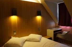 - une chambre avec un lit avec deux oreillers et un bureau dans l'établissement Hôtel-Restaurant Mont Sainte-Odile, à Ottrott