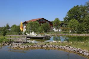 a pool of water with a playground and a house at Villa Waldeck in Eppingen