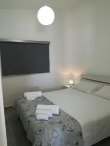 a bedroom with a large bed with towels on it at TERRAZZA SUL MARE in Punta Secca