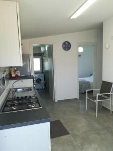 a kitchen and living room with a stove top oven at TERRAZZA SUL MARE in Punta Secca