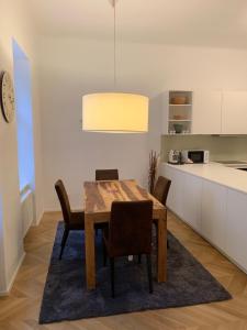 a dining room with a wooden table and chairs at KH Apartments Stephansplatz in Vienna