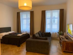 a living room with a couch and a bed at KH Apartments Stephansplatz in Vienna