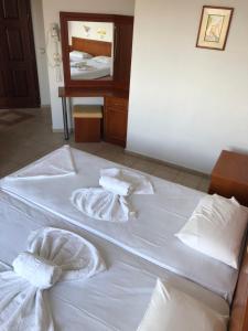 Posteľ alebo postele v izbe v ubytovaní Kyma Hotel