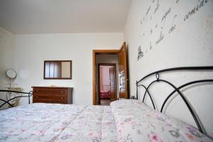 A bed or beds in a room at La Casa Dei Nonni