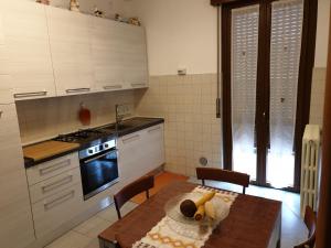 cocina con mesa y fogones horno superior en Tranquillità e cordialità a 30 minuti da MIlano, en Busto Arsizio