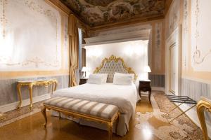 a bedroom with a king sized bed and ornate walls at Ca' Bonfadini Historic Experience in Venice