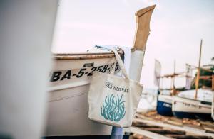 una borsa appesa al lato di una barca di Hostal Ses Negres a Begur