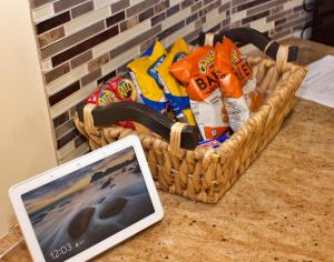 a laptop computer sitting next to a basket of chips at Chic Downtown In-Law Suite in Washington, D.C.