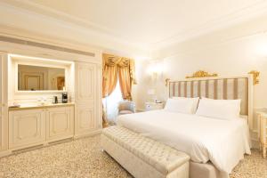 a bedroom with a large white bed and a mirror at Ca' Bonfadini Historic Experience in Venice