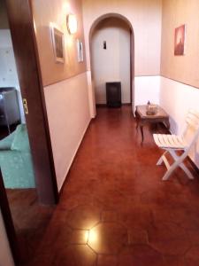 a hallway with a table and chairs in a room at 3 vani 700 Mt mare e 3000 Mt da Capo D'Orlando in Naso