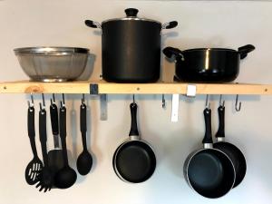 a shelf with pots and pans and utensils at The Madison House in Minneapolis