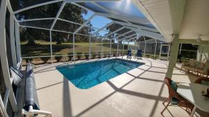 a swimming pool on a house with a patio at Villa Willow Wood - Golfcourse in Inverness