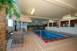 a swimming pool in a hotel room with a resort at Super 8 by Wyndham Troy IL/St. Louis Area in Troy