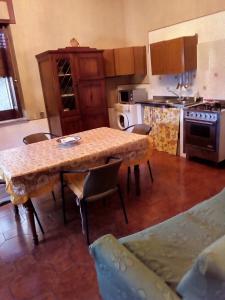 a kitchen with a table and chairs in a room at 3 vani 700 Mt mare e 3000 Mt da Capo D'Orlando in Naso