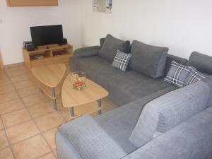 a living room with a couch and a table at Ferienwohnung Erpel in Olpe
