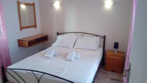 a bedroom with a bed with two towels on it at Marietta's Apartments in Agios Andreas