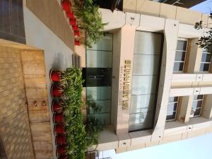 a building with a vertical garden on the side of it at Blueberry Inn in Raipur