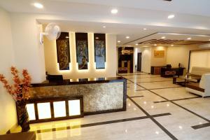 a lobby of a hotel with a reception desk at Blueberry Inn in Raipur