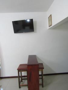 a room with a table and a tv on a wall at Contemporary Ocean and Garden- view Studio in Mearnsville