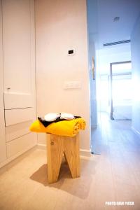 a yellow surfboard sitting on top of a wooden floor at Hotel Cala Saona & Spa in Cala Saona