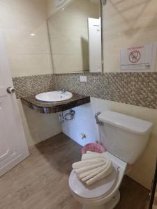 a bathroom with a white toilet and a sink at The Krabi Forest Homestay in Ao Nang Beach