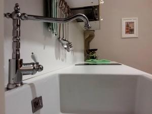a kitchen sink with a faucet above it at Dimora del Castellano in Gioia del Colle