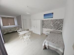 a bedroom with a bed and a table and chairs at Mountains View in Castellammare del Golfo