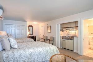 a bedroom with a large bed and a kitchen at Wades Point Inn on the Bay in Saint Michaels