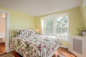 a bedroom with a bed and a window at Wades Point Inn on the Bay in Saint Michaels