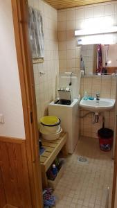 a small bathroom with a toilet and a sink at Ojuspirtti 26B Levi in Levi