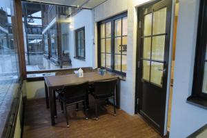 a table and chairs in a room with windows at Apartments Golf in Tahkovuori +4 photos