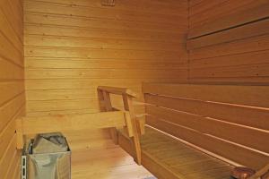 an empty wooden sauna with a bench in it at Apartments Golf in Tahkovuori