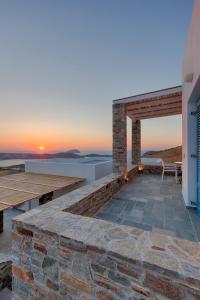 a patio with a view of the ocean at sunset at Serifos Blue in Rámos
