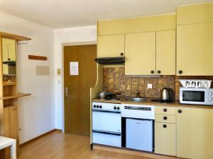 a kitchen with a white stove and a microwave at central beauty scenery apartment in Interlaken