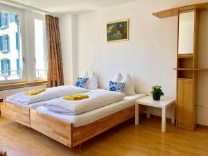 a bedroom with a large bed with a wooden frame at central beauty scenery apartment in Interlaken