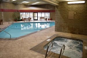 a large swimming pool with a hot tub in a building at Gateway Hotel and Conference Center in Ames