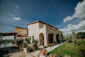 a brick building with plants in a yard at Stone house in Novi Velia