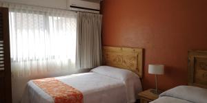 um quarto com uma cama grande e uma janela em Estrella de Mar em Puerto Vallarta