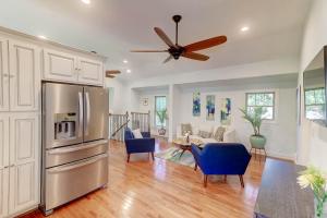 a kitchen with a stainless steel refrigerator and blue chairs at The Cottage at DuPont in Charleston