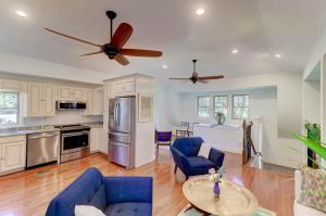 a large kitchen with blue chairs and a table at The Cottage at DuPont in Charleston +30 photos